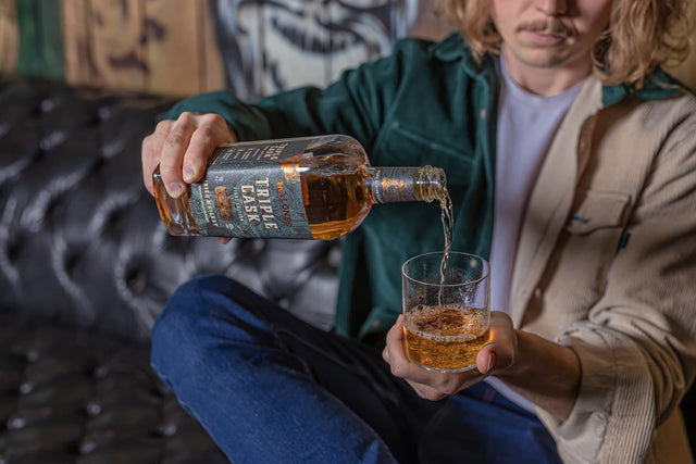 A bottle of Malones Irish Whiskey being poured