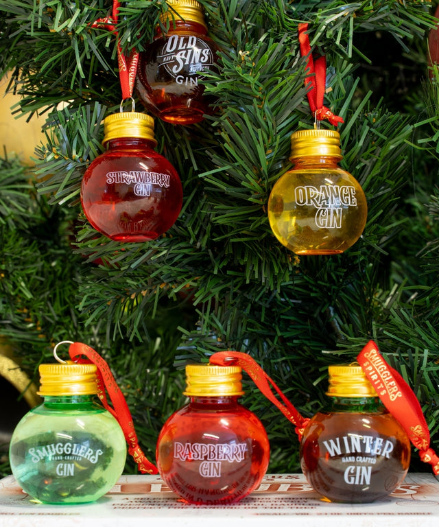 Gin Baubles from a gift set for gin lovers hanging from a Christmas tree